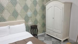 a bedroom with a bed and a cabinet in it at B&B By the Station in Battipaglia
