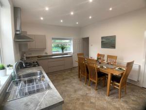 a kitchen with a table and chairs in a kitchen at CrowTrees in Brighouse