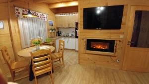 a living room with a table and a fireplace at Domki Białka & Apartamenty in Białka Tatrzanska