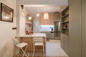 a kitchen with a table and chairs and a refrigerator at Urban Jasmine in Thessaloniki