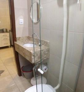 y baño con ducha, aseo y lavamanos. en Kit 6 Residencial Diego Marcelo, en Itapema