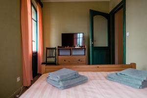 a bedroom with a bed with two blue towels on it at Na Kopečku AD 1795 - penzion, restaurace, privátní wellness in Dvůr Králové nad Labem