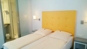 Postel nebo postele na pokoji v ubytování Altstadt Hotel Baunachshof
