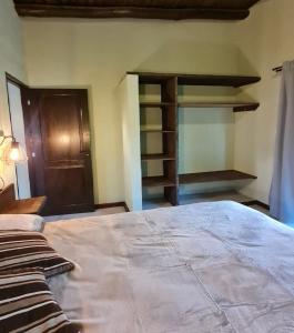 a bedroom with a large bed and a closet at Cabañas Altos de San Blas in San Javier +19 photos