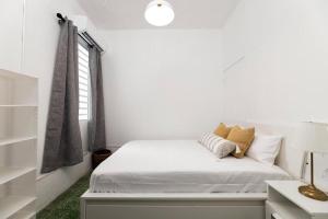 a white bedroom with a bed and a window at Digital Nomad San Agustin Apartments in San Juan +40 photos