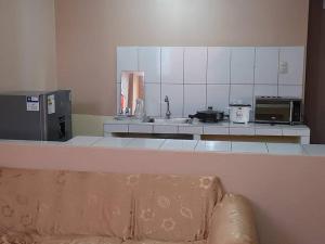 a kitchen with a sink and a counter with a couch at Kely2 Tercer Piso in Lima