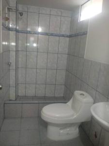 a bathroom with a toilet and a shower and a sink at Kely2 Tercer Piso in Lima