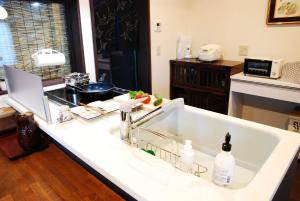 a kitchen counter with a sink in a kitchen at Kanazawa Hitomuneyado Kaisen - Vacation STAY 94237v in Kanazawa