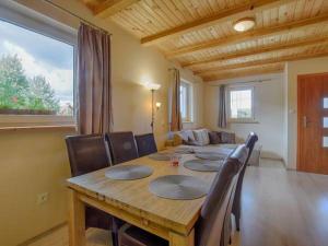 a dining room with a table and chairs and a couch at Apartamenty Wiktora in Polanica-Zdrój