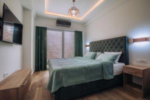 a bedroom with a large bed and a window at White Blue Ohrid - Luxury Apt, City Center, Private Parking, Balcony, near Ohrid Lake in Ohrid