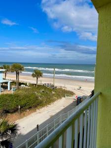 a view of the beach from a balcony at Ocean Overlook - Sea View at Symphony Beach Club! in Ormond Beach