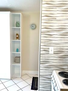 a kitchen with a stove and a wall at Ocean Overlook - Sea View at Symphony Beach Club! in Ormond Beach