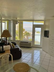 a living room with a couch and a view of the ocean at Ocean Overlook - Sea View at Symphony Beach Club! in Ormond Beach