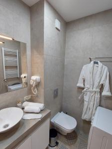 a bathroom with a white toilet and a sink at New Gudauri Redco TWINS-Premium Mountain Apartment Close The Gondola lift in Gudauri +53 photos