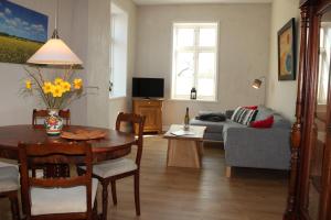 a living room with a table and a couch at Alte Meierei Twedt in Twedt