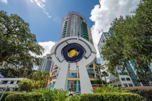 a tall building with a clock tower in front of it at Business District Apartments by Barsala in Orlando