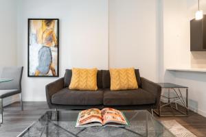 a living room with a couch and a glass table at Business District Apartments by Barsala in Orlando