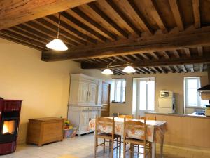 a kitchen with a table and chairs in a room at Gîte du Morvan in Saint-Germain-des-Champs +8 photos