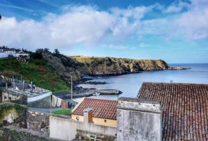 a view of a body of water with houses and a coast at Ribeirinha House in Porto Formoso