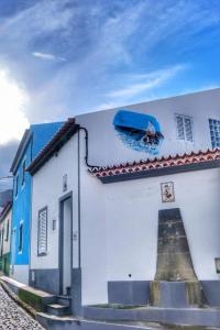 a building with a painting on the side of it at Ribeirinha House in Porto Formoso