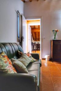 a couch with pillows on it in a living room at Ribeirinha House in Porto Formoso