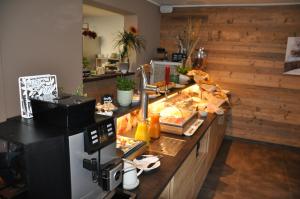 a kitchen with a counter with food on it at Himmelsbögen und Apartments mit Seeblick und Alleinlage in Weissensee +224 photos