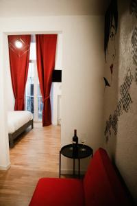 a living room with a red couch and a table at BED and BREAKFAST il Duomo in Ascoli Piceno