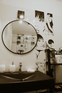 a bathroom with a mirror and a sink at BED and BREAKFAST il Duomo in Ascoli Piceno