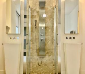 a shower with a glass door in a bathroom at Charming La Casa de La Castellana in Madrid