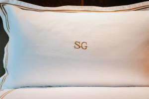 a white pillow with the word ss written on it at Soho Grand Hotel in New York