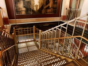 an empty staircase with metal railing in a building at Soho Grand Hotel in New York