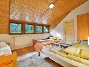 a bedroom with two beds in a room with wooden ceilings at Willa Nadin in Szklarska Poręba