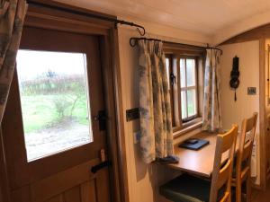 a room with a wooden table and a window at Woody's Retreat in Bolton by Bowland +18 photos