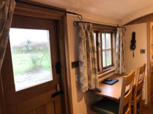 a room with a wooden table and a window at Woody's Retreat in Bolton by Bowland