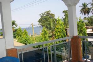 a balcony with a view of the ocean at Maison MIDAREA in Kribi