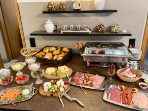 a table topped with lots of different types of food at Landhaus am Itterbach Willingen in Willingen