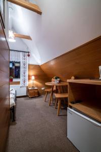 a room with a table and a dining room at Willa Cicha Woda Centrum in Zakopane
