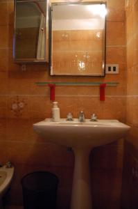 a bathroom with a sink and a mirror at Appartamento Cerreto Laghi in Cerreto Laghi