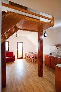 a living room with a red couch and a table at Vineyard Cottage Lustek in Novo Mesto