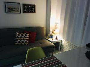 Kitnet aconchegante Beira Mar. في سانتوس: غرفة معيشة مع أريكة وطاولة