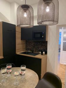 a kitchen with a table with wine glasses on it at Bella Vista Collonade in Karlovy Vary +15 photos