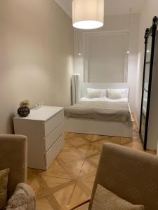 a bedroom with a bed and a table and chairs at Bella Vista Collonade in Karlovy Vary