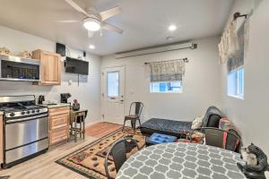 a kitchen and living room with a couch and a table at Cozy Studio in Downtown Williams with Patio! in Williams