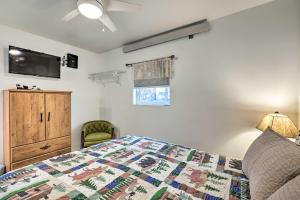 a bedroom with a bed and a tv and a chair at Cozy Northern Arizona Studio in Downtown Williams! in Williams