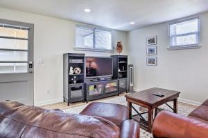 a living room with a couch and a tv at Cozy Rapid City Retreat Perfect for Exploring! in Rapid City
