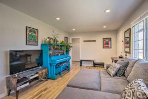 a living room with a couch and a flat screen tv at Centrally Located Aurora Home w/ Covered Patio in Aurora