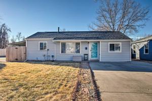a white house with a driveway in front of it at Centrally Located Aurora Home w/ Covered Patio in Aurora