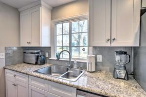 a kitchen counter with a sink and a blender at Comfy Aurora Hideout with Yard and Covered Patio! in Aurora