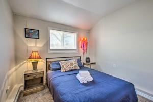 a bedroom with a blue bed and a window at Centrally Located Aurora Home w/ Covered Patio in Aurora