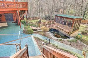 a house with a bridge over a small pond at Lovely Mountain Apartment with Patio and Koi Pond! in Asheville